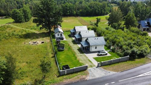 an aerial view of a house on a hill next to a road at Domki Pod Dębem in Sulęczyno