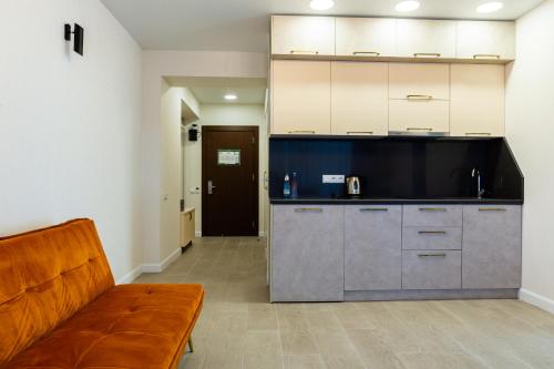 a living room with a couch and a kitchen at The SPOT apartments - Orbi Beach Tower in Batumi