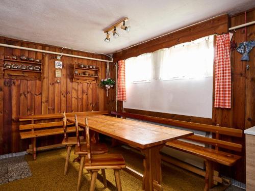 a dining room with a wooden table and chairs at Apartment Nový Svět by Interhome in Harrachov