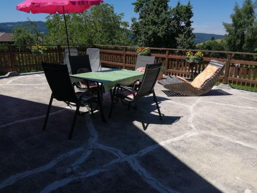 a table and chairs with an umbrella on a patio at Holiday Home Mayrhofer by Interhome in Oberwang