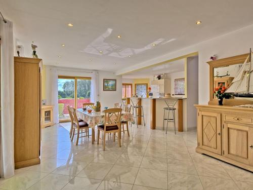 a kitchen and dining room with a table and chairs at Holiday Home Ty Ker by Interhome in Lannion