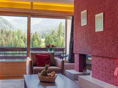 a living room with a couch and a fireplace at Apartment Rosablanche C61 by Interhome in Siviez