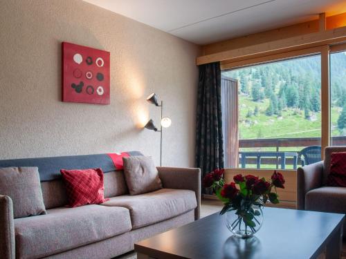 a living room with a couch and a table at Apartment Rosablanche C51 by Interhome in Siviez