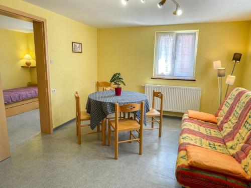 a living room with a table and a couch at Apartment Résidence jaune et rose-1 by Interhome in Marckolsheim