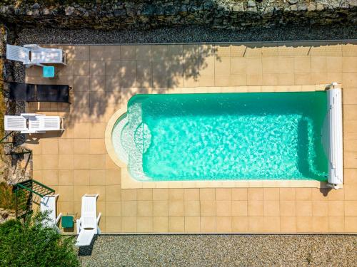 an overhead view of a swimming pool with two chairs at Holiday Home Le Moulin - SGB100 by Interhome in Saint-Genest-de-Bauzon