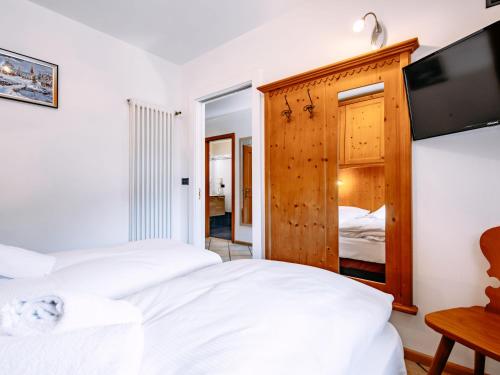 a bedroom with two beds and a flat screen tv at Apartment Carmen-3 by Interhome in Soraga