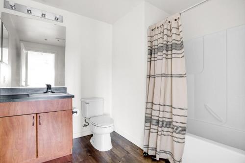 a bathroom with a toilet and a sink and a shower at Downtown Bellevue 2BR w WD Storage nr Shops SEA-223 in Bellevue