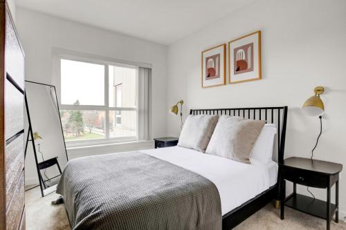 a white bedroom with a bed and a window at Downtown Bellevue 2BR w WD Storage nr Shops SEA-223 in Bellevue