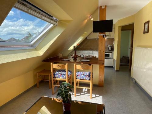 a kitchen with a table and chairs and a window at Apartment Résidence jaune et rose-3 by Interhome in Marckolsheim