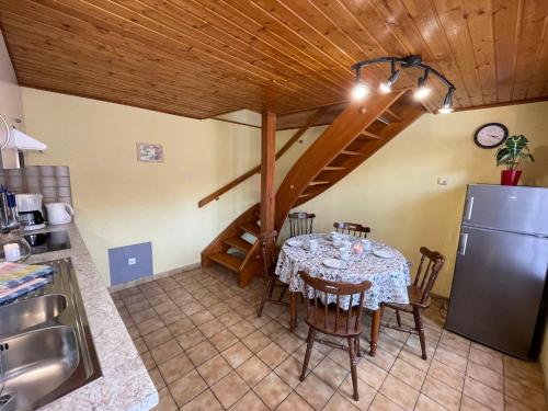 a dining room with a table and a refrigerator at Apartment Résidence jaune et rose-4 by Interhome in Marckolsheim