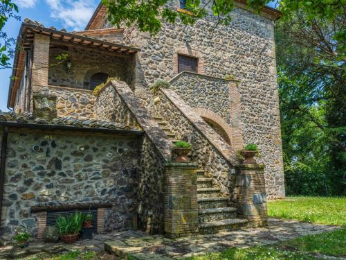 an old stone building with stairs in front of it at Apartment La Capraccia-5 by Interhome in Bagnoregio