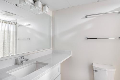 a white bathroom with a sink and a mirror at Ballston 1br w wd gym pool nr Metro WDC-616 in Arlington