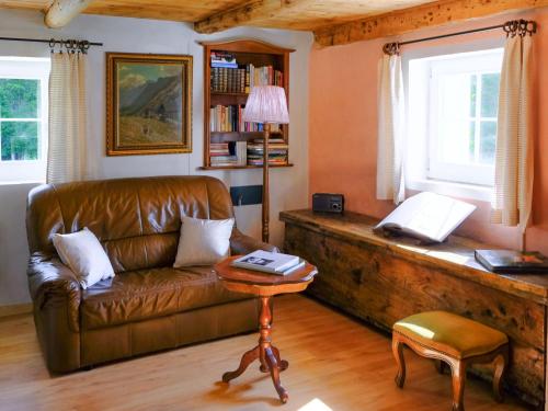 a living room with a leather couch and a table at Holiday Home Casa Felice by Interhome in Anvéuda