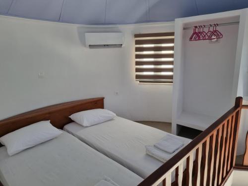 a bedroom with two beds and a balcony at Panorama Studios in Faliraki