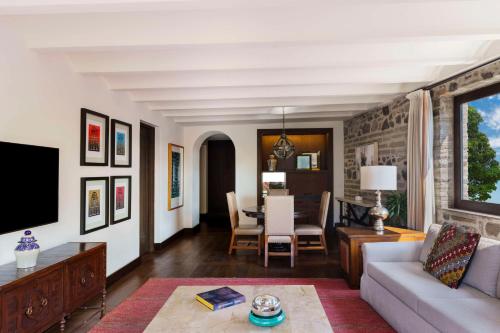 a living room with a couch and a table at Banyan Tree Puebla in Puebla