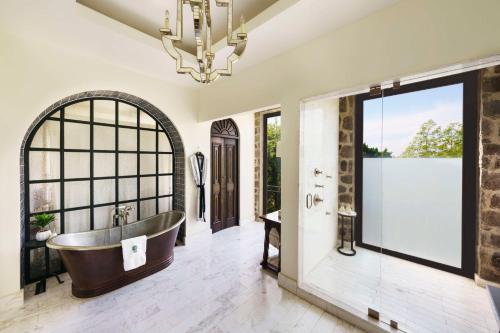 a bathroom with a tub and a window at Banyan Tree Puebla in Puebla