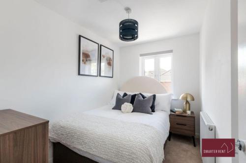 a white bedroom with a bed and a window at Guildford - 3 Bedroom Home - Driveway & Garden in Guildford