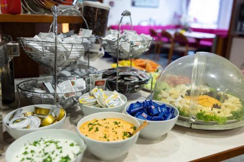 a table topped with bowls of food on a counter at Sommerhotel Karwendel in Innsbruck