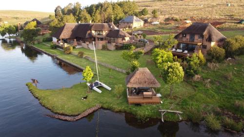 an island in the middle of a river with houses at Sedgefield Lodge in Witbank