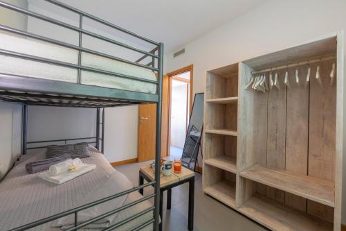 a bedroom with two bunk beds and a desk at Residence degli Oleandri 2A in Argegno
