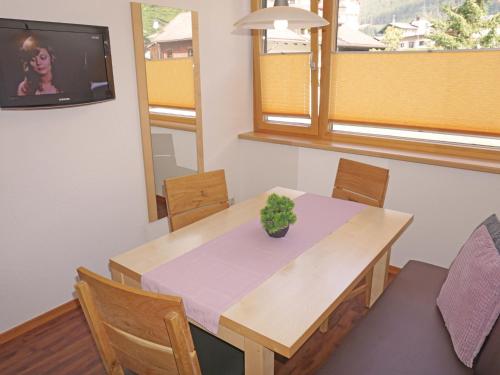 a dining room with a table with a plant on it at Apartment Flirscherblick by Interhome in Flirsch