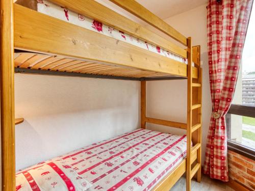 a bunk bed in a room with a bunk bed in a bedroom at Apartment Belleville Caron-11 by Interhome in Les Menuires