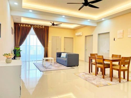 a living room with a dining table and a tv at Taraa Lodge PutrajayaMuslim in Putrajaya