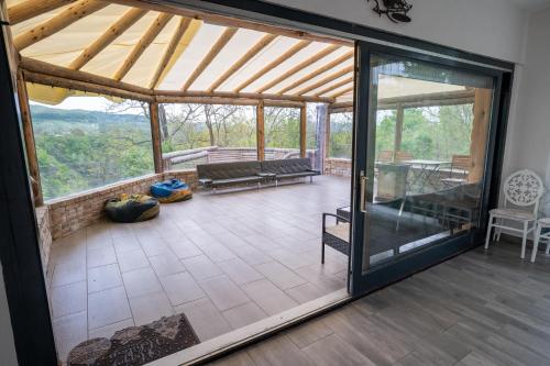 an open living room with a large glass door at Bârlogul Vikingilor in Şotrile