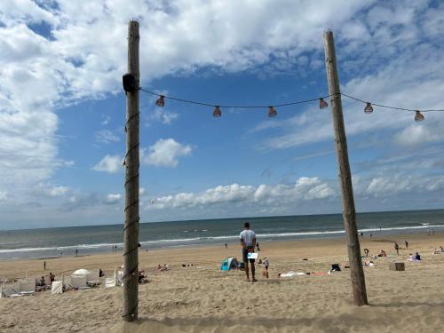 a man standing on the beach looking at the ocean at Holiday Home Stern Comfort-2 by Interhome in Noordwijk