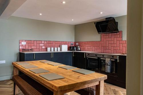 a kitchen with a wooden table in a kitchen at High Tide in Redcar