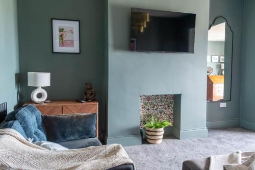 a living room with a fireplace and a tv at High Tide in Redcar