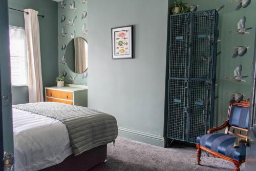 a bedroom with a bed and a dresser and a chair at High Tide in Redcar