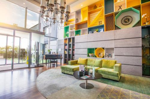 a living room with a couch and a table at Holiday Inn Mulhouse, an IHG Hotel in Mulhouse