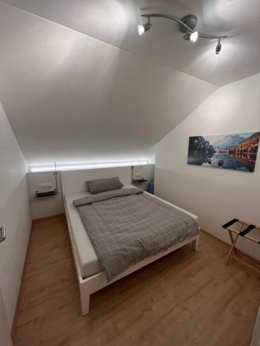 a bedroom with a bed in a white room at Wohlfühl Apartment in Wendelstein