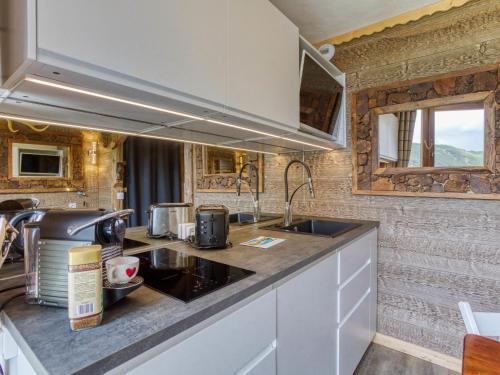 a kitchen with a sink and a counter top at Apartment Belleville Caron-12 by Interhome in Les Menuires