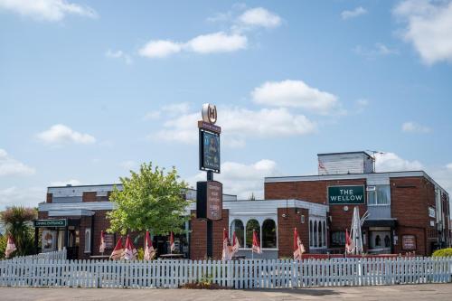 a building with a clock tower in front of it at Wellow Hotel in Cleethorpes
