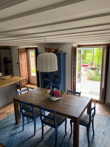 a dining room with a wooden table and chairs at Quinta dos Pegões in Tomar