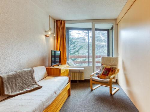 Zimmer mit einem Sofa, einem Stuhl und einem Fenster in der Unterkunft Apartment Chanteneige La Croisette-4 by Interhome in Les Menuires