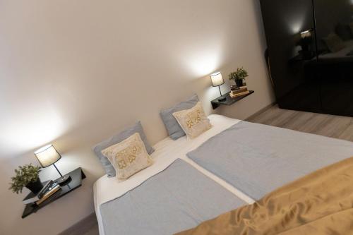 a bedroom with a large bed with two pillows at Friends Hostel & Apartments in Budapest