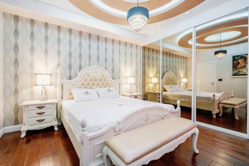 a bedroom with a white bed and a mirror at Victoria Residence Apartments in Budva