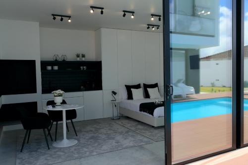 a bedroom with a bed and a swimming pool at Condessa Home in Ponta Delgada