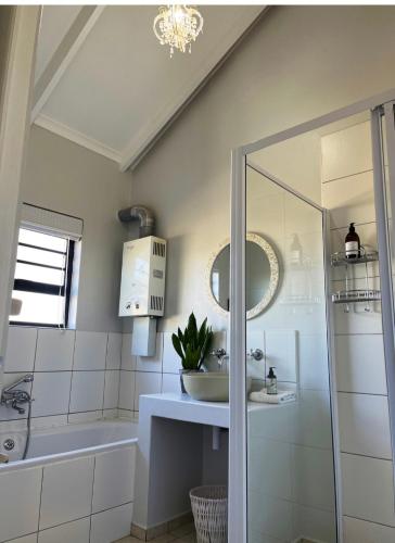 a white bathroom with a sink and a mirror at Accommodation @Sea Trader in St. Helena Bay