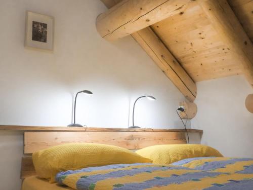 a bedroom with two beds and two lamps on the wall at Holiday Home Rustico La Dimora by Interhome in Malvaglia