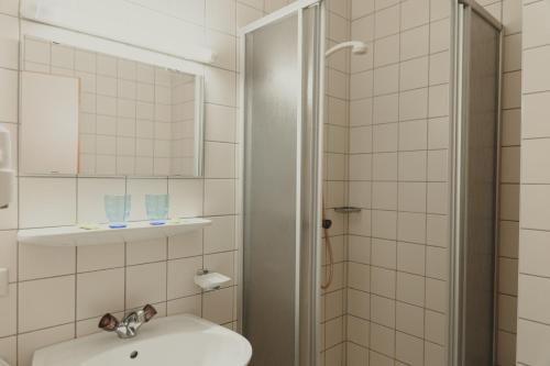 a bathroom with a sink and a shower at Sommerhotel Karwendel in Innsbruck