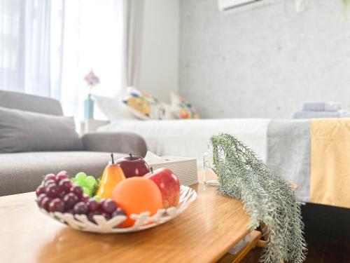 a bowl of fruit on a table in a living room at nestay inn tokyo ryogoku in Tokyo