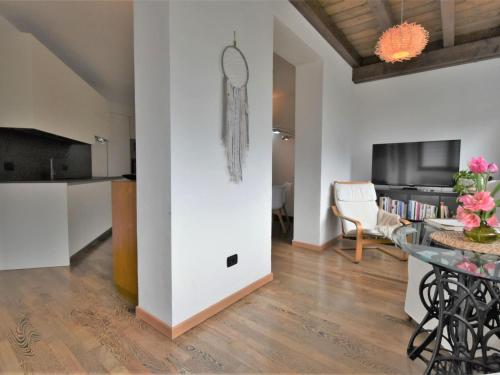 a living room with a table and a dining room at Apartment Valley View Pool Apartment by Interhome in Ardenno