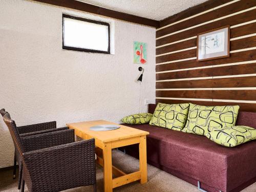 a living room with a couch and a table at Apartment Harrachov 387 by Interhome in Harrachov