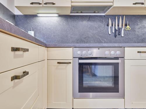 a kitchen with white cabinets and an oven at Apartment Marika 1 by Interhome in Cerny Dul