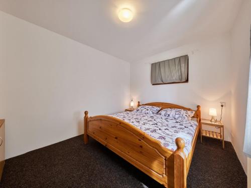 a bedroom with a wooden bed in a room at Apartment Marika 1 by Interhome in Cerny Dul
