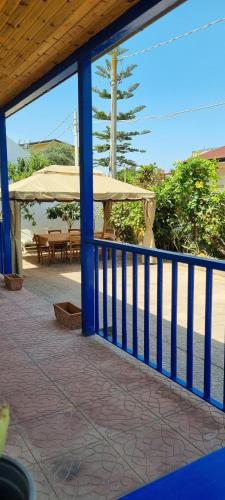a porch with a blue fence and a picnic table at Villa Rosetta - Casa Vacanze in Palmi